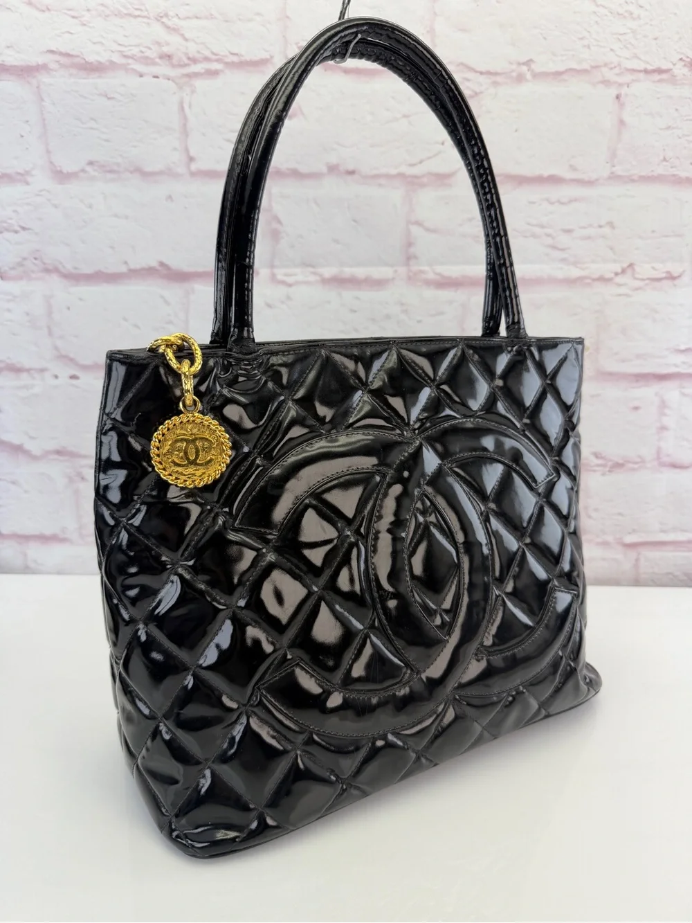 CHANEL Black Quilted Patent Leather Tote with Gold Medallion Charm